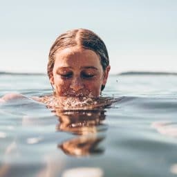 woman with her head half way in water
