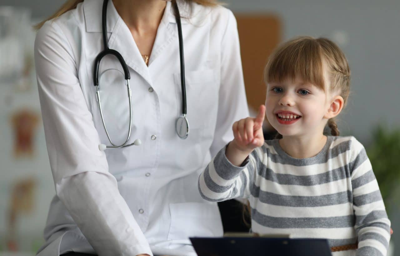 Child playing with a doctor in an office.