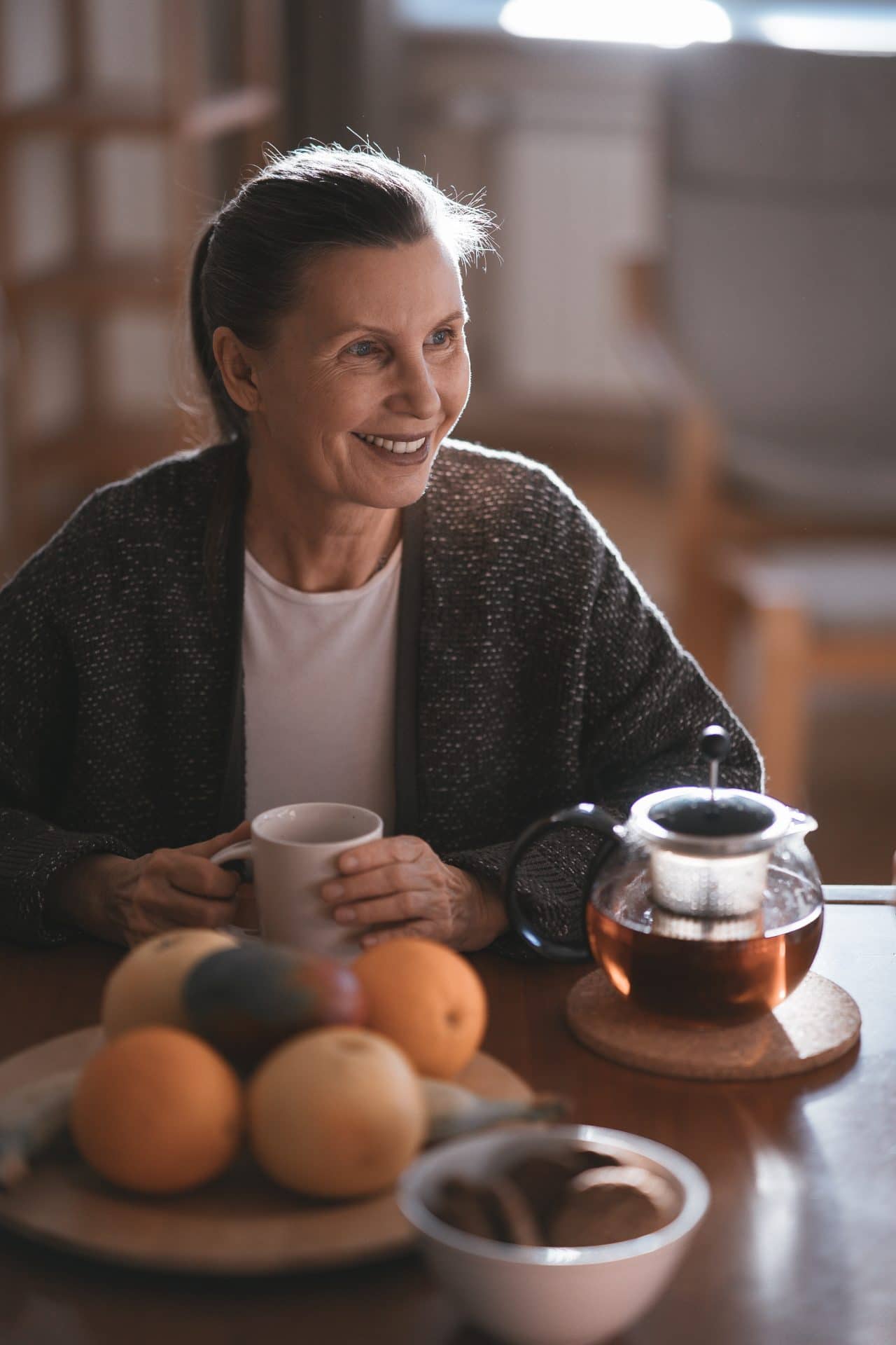 Middle-aged woman enjoying a cup of tea.