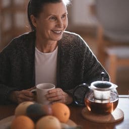 Middle-aged woman enjoying a cup of tea.