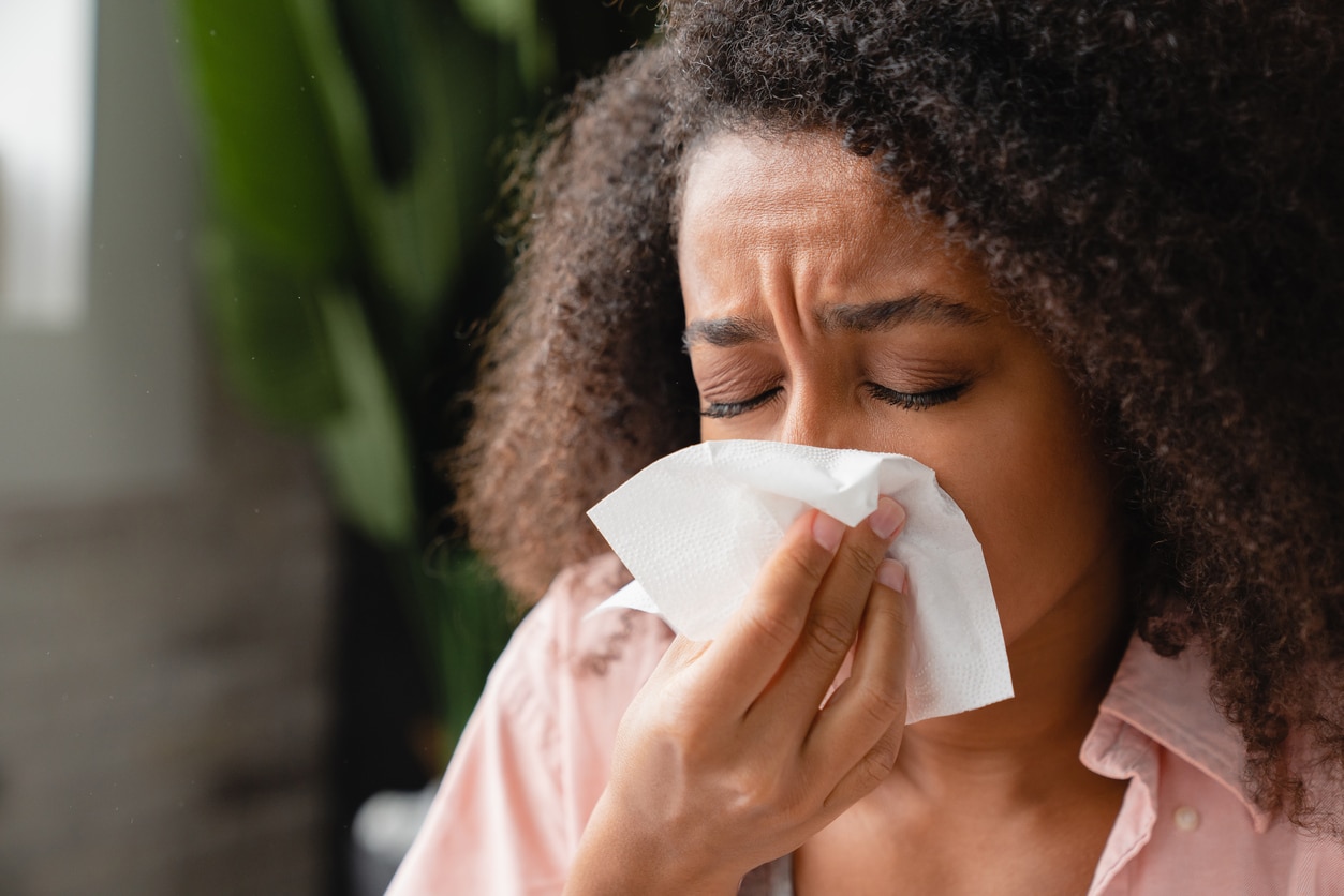 Woman blowing her nose