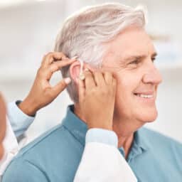 Happy man at his hearing aid fitting
