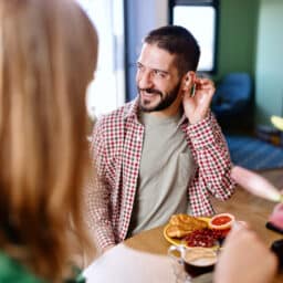 Man with hearing aid enjoys dinner